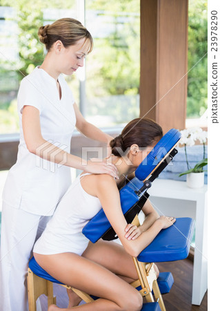 Woman receiving shoulder massage 23978290