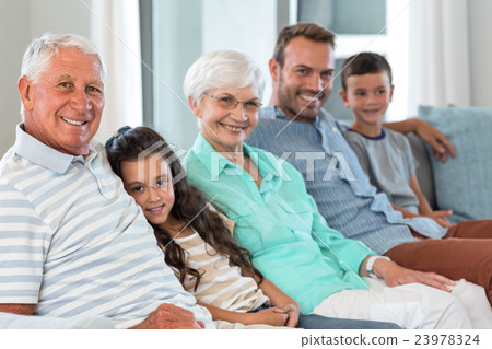 Happy family sitting on sofa 23978324