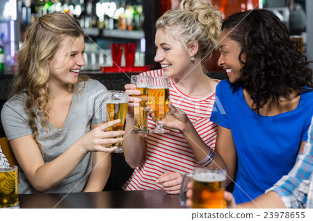 Happy friends having a drink Happy friends having a drink 23978655