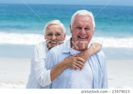 Senior couple embracing with arms around 23979023