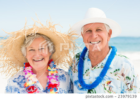 Senior couple standing at the beach 23979139