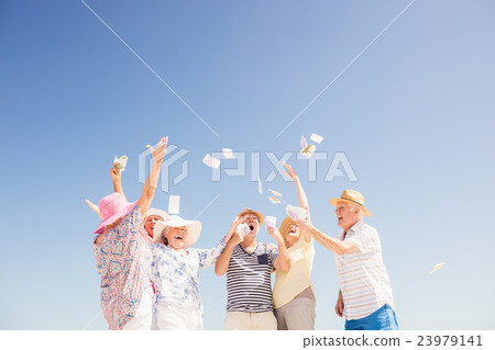 Happy senior throwing money 23979141