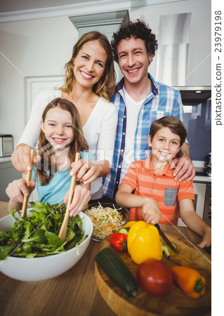 Portrait of happy parents with children in kitchen 23979198