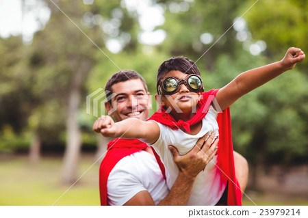 Father and son pretending to be superhero 23979214