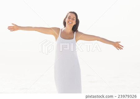 Beautiful woman stretching on the beach Beautiful woman stretching on the beach 23979326