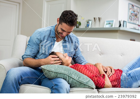 Romantic couple relaxing on sofa 23979392