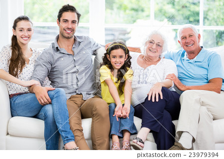 Portrait of smiling family with grandparents on sofa 23979394