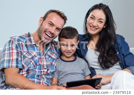 Mother, father and son using digital tablet Mother, father and son using digital tablet 23979518