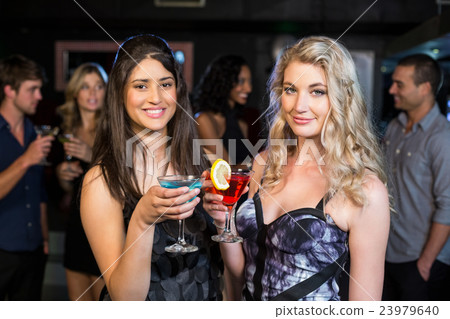 Portrait of friends having a drink 23979640