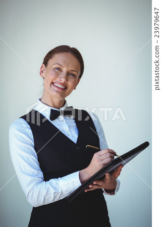 Smiling waitress taking an order Smiling waitress taking an order 23979647