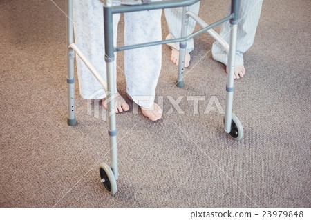 Low section of elderly man and woman with walker Low section of elderly man and woman with walker 23979848