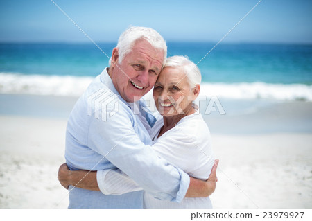 Senior couple embracing head to head Senior couple embracing head to head 23979927
