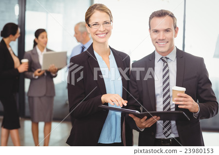 Portrait of businessman and businesswoman holding file Portrait of businessman and businesswoman holding file 23980153