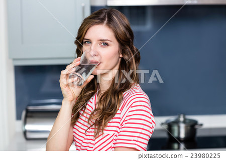 Portrait of beautiful young woman drinking water Portrait of beautiful young woman drinking water 23980225