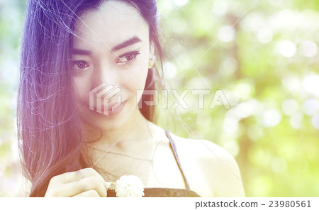 portrait of charming woman in garden 23980561