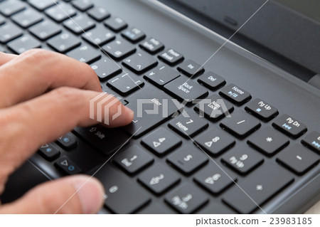 Black laptop and hand 23983185