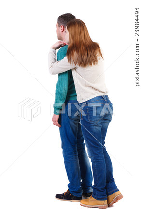 Back view of young embracing couple hug and look Back view of young embracing couple hug and look 23984493