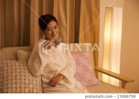 Middle female drinking herb tea before going to bed 23986798