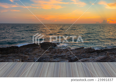 Sunset sky over seacoast with natural rock 23991837