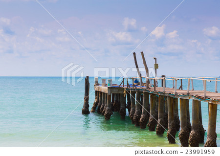 Fishing jetty over seacoast skyline 23991959