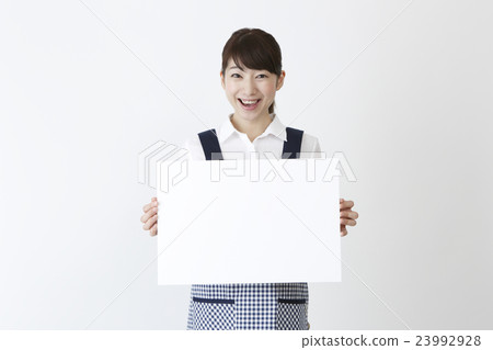 A woman in an apron with a message board 23992928