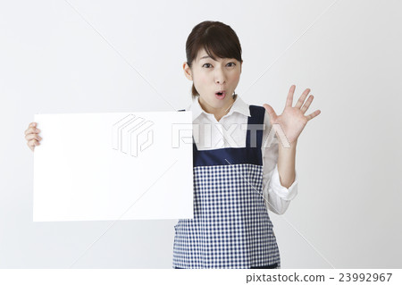 A woman in an apron with a message board A woman in an apron with a message board 23992967