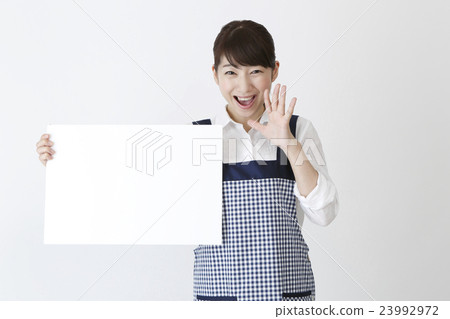 A woman in an apron with a message board 23992972