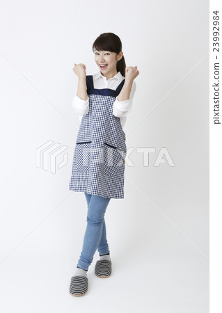 A woman in an apron A woman in an apron 23992984