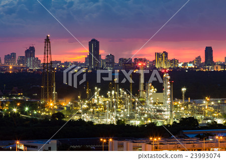 Oil refinery night view with city downtown Oil refinery night view with city downtown 23993074