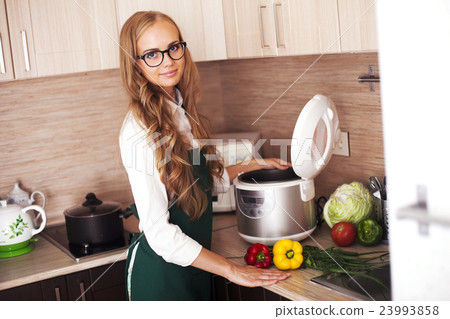 beautiful girl with slo-cooker 23993858