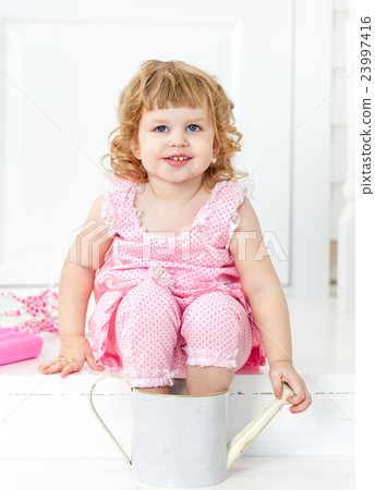Little cute curly girl sitting on porch Provence Little cute curly girl sitting on porch Provence 23997416