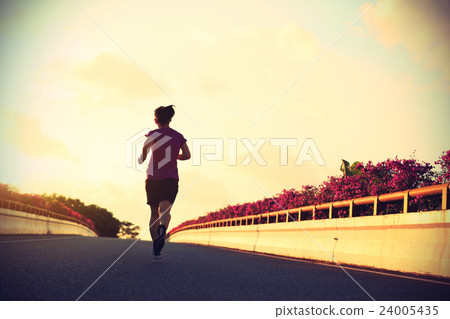 young woman runner running on city bridge road 24005435
