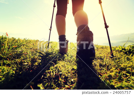 woman backpacker  on sunrise mountain peak 24005757