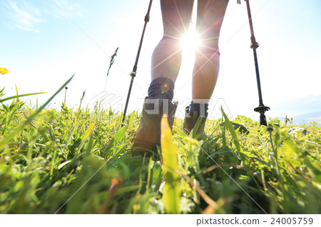 woman backpacker on sunrise mountain peak 24005759
