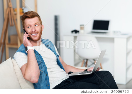 Joyful man sitting on the couch 24006733