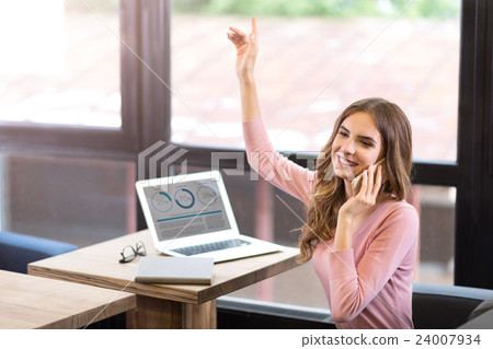 Joyful woman talking on cell phone Joyful woman talking on cell phone 24007934