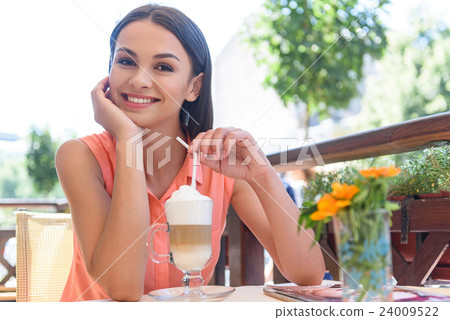 Cute smiley woman resting in cafe Cute smiley woman resting in cafe 24009522