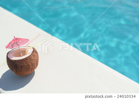 Tropic beverage in nut near water Tropic beverage in nut near water 24010334