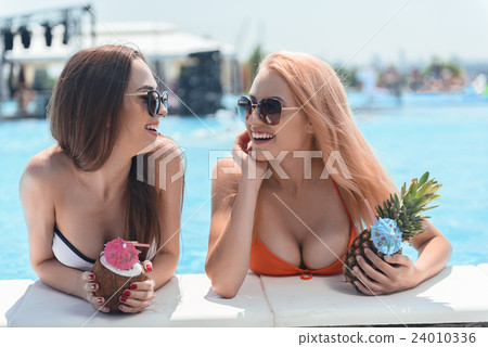 Cheerful young women relaxing in water with Cheerful young women relaxing in water with 24010336