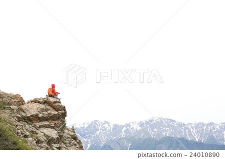 woman backpacker hiking  on mountain peak cliff 24010890