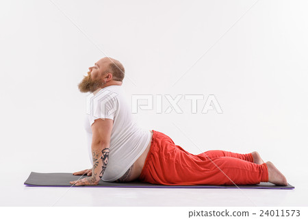 Relaxed fat man doing yoga 24011573