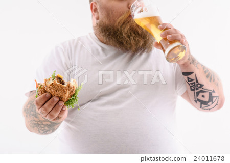 Fat guy enjoying unhealthy food and drink 24011678