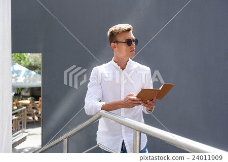 Confident guy entertaining with modern technology Confident guy entertaining with modern technology 24011909