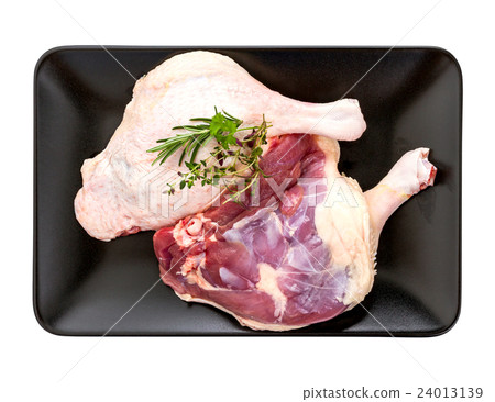 Muscovy duck leg with herb on black plate Muscovy duck leg with herb on black plate 24013139