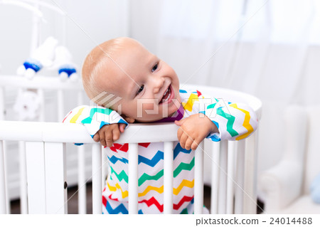 Little boy standing in bed Little boy standing in bed 24014488