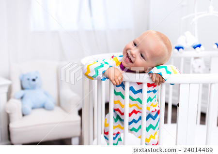 Little boy standing in bed Little boy standing in bed 24014489