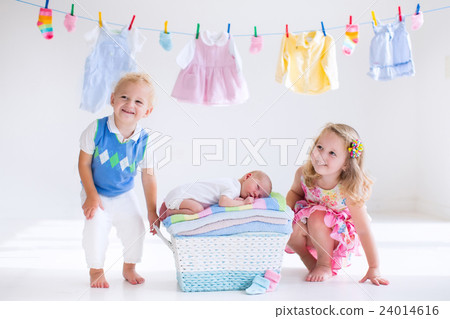 Brother and sister kissing newborn baby Brother and sister kissing newborn baby 24014616