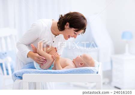Mother and baby on changing table 24016103
