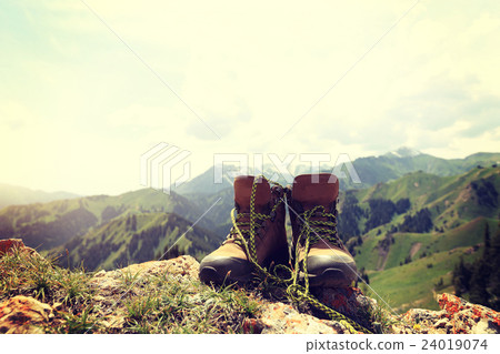 hiking boots on beautiful mountain peak 24019074