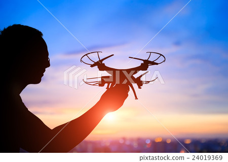silhouette of man take drone 24019369